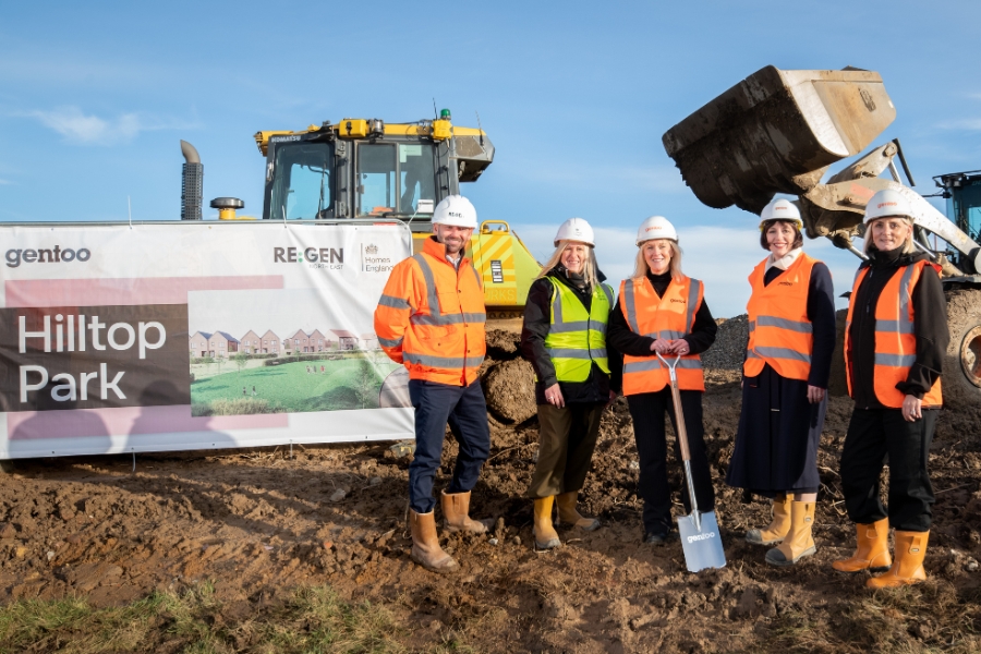 5 people in front of a digger