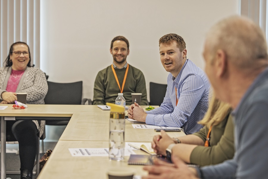 Gentoo colleagues and customers sitting at a table during a meeting