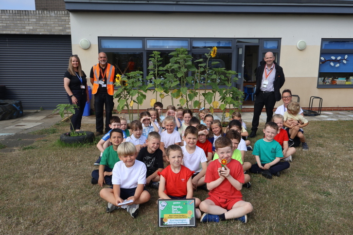 Students of East Herrington Primary Academy with Gentoo colleagues after winning the Best School Garden award.